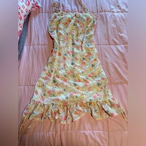 Cottagecore style floral dress with a frilly hem and adjustable straps.